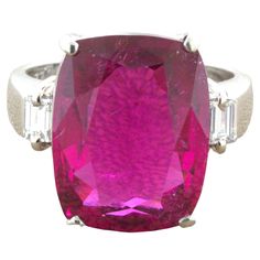 10.44 Carat Rubellite Tourmaline Diamond Platinum 3-Stone Ring A juicy and vibrant rubellite tourmaline takes center stage. The cushion-cut gem weighs an impressive 10.44 carats and has an intense bright and lively red color that sparkles in the light. It is complemented by two baguette-cut diamonds set on its sides weighing 0.20 carats total. Hand-fabricated in platinum and ready to be worn. Ring Size 6.25 Weight: 10.9 grams Kubler Ross, Rubellite Tourmaline, 3 Stone Rings, Baguette Cut Diamond, Baguette Cut, Gem Stone, Center Stage, Cushion Cut, Stone Ring