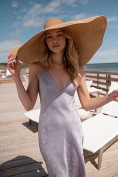 The Jenny Yoo Leilani slip dress is a chic and modern update to the classic slip dress. Featuring a V neck and a delicate spaghetti strap to highlight your shoulders and collarbone. The low scoop back has a barely there feeling, and the bias cut skirt slinks over every curve. A dainty tie at the back adds one last flirtatious detail. Available in Clay Rosette Pink and Oxford Blue. Ready to ship. Shop online now! Spaghetti Strap Lined Midi Dress For Brunch, V-neck Slip Dress With Delicate Straps For Wedding, Feminine Fitted Slip Dress For Summer, V-neck Slip Dress With Delicate Straps, Feminine V-neck Slip Dress With Delicate Straps, Summer Backless Dress With Built-in Bra And Low Back, Chic Beach Slip Dress With Built-in Bra, Chic Backless Dress With Spaghetti Straps And Built-in Bra, Spaghetti Strap Slip Dress For Beach