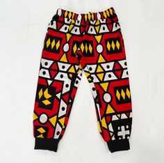 Really cute jogger style soft comfortable pant in African print fabric  The pants have a no roll comfortable waistband, front pockets, and ribbed 'joggers style' ankles. The pants have a no roll comfortable waistband, front pockets, and black rubbed ankles. These pants are comfy! And easy to pull on or off for kids and toddlers. This would make a super cute gift for a girl or boy!  Orders are made and shipped within 1-3 business days. Regular shipping takes 2-6 days, and you can also upgrade to express shipping for an additional fee. Express shipping takes 1-4 days. Please let me know if you have a date you need your order by, I'll try to accommodate that as much as I can. Please check the sizing charts in the images, send me a message if you need custom sizing. Check out our main page for