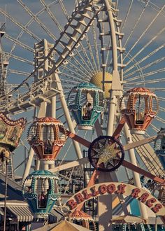 an amusement park ferris wheel with lots of rides