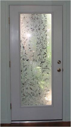 a white door with etched glass on it