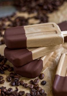 chocolate pops are stacked on top of coffee beans