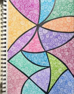 a spiral notebook with an abstract design on it