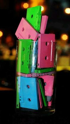 a glass filled with lots of different colored boxes