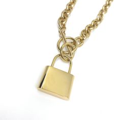 This beautiful gold lock chain statement necklace is a must have for any jewelry collection. A classic The length of this necklace is 18 inches and the material we use as base stainless steel and then 14K gold platted. It is a very unique style that can be easily combined. Very fashionable and unique style. If you are giving this as a gift you can rest assure that they will love you for this pick ;) - Good quality material - 14k Gold Platted - Fashionable Necklace - Perfect Length - Easy to wear Gold Chain Link Necklace With Lock, Metal Chain Necklace With Lock For Gift, Metal Chain Link Necklace With Lock, Gold Chain Necklace With Lock For Gift, Taurus Jewelry, Lock Chain, Chunky Gold Chain, Lock Necklace, White Necklace