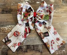 "Celebrate the season of the Nutcracker with this adorable cotton fabric hair bow . Bow comes in a fabric drawstring storage bag. Bow Details: *Bow is made of cotton fabric that has Nutcracker and ornament images throughout. *Bow measures approximately 5.5\" across (measured from left side to right side). *Bow tails measure approximately 5.5\" long (measured from the bottom of the center of the bow to the tip of the bow tail). *Bow sits on a 1.75\" French Barrette lined with red grosgrain ribbon Red Nutcracker, Fabric Hair Bow, Fabric Hair Bows, Bow Bow, The Nutcracker, French Barrette, How To Make Bows, Nutcracker, Grosgrain Ribbon