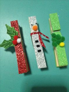 three pieces of crafting made to look like pencils with snowmen on them