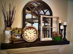 a clock sitting on top of a mantle next to vases and other decor items