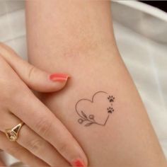 a woman's arm with a small tattoo on it