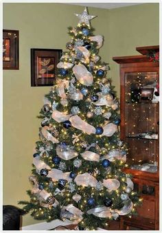 a decorated christmas tree with blue and silver ornaments