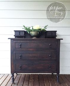 an old dresser with some flowers on top