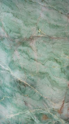 green marble textured with gold veining and red streaks on the top right side