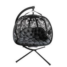 a black and white chair with butterfly print on the back, hanging from a metal stand