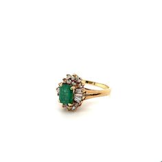 Ring Details: ✔ Gold Karat: 14K ✔ Ring Size: 7 ✔ Ring Weight: 3.9 grams ✔ Mounting: Prong ✔ Shank: Cathedral ✔ Diamonds: (6 baguette-cut diamonds, 0.24ctw) (14 round cut diamonds, 0.19ctw)  Emerald Details: ✔ Carat: 1.00 ✔ Cut: Emerald ✔ Origin: Colombia ✔ Color: Green (deep) ✔ Clarity: Very good ✔ Luster: Excellent Vintage natural Emerald and natural diamond ring in 14k solid yellow gold. This vibrant Emerald bears excellent color and luster. It's well contrasted by a round and baguette-cut dia Oval Yellow Gold Emerald Ring With Multi-stone, Oval Yellow Gold Emerald Ring With Multiple Stones, Yellow Gold Multi-stone Emerald Cut Diamond Ring, Yellow Gold Emerald Cut Multi-stone Ring, Anniversary Yellow Gold Multi-stone Emerald Ring, 14k Gold Multi-stone Baguette Cut Ring, Classic Multi-stone Yellow Gold Emerald Ring, 14k Gold Multi-stone Emerald Cut Diamond Ring, Yellow Gold Cluster Ring With Emerald Cut May Birthstone