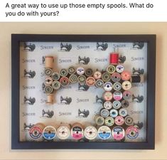 a shadow box with buttons and spools in it