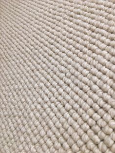 a close up view of a white rug