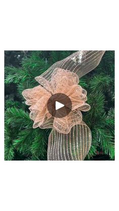 a christmas ornament hanging from the side of a tree with an image of a flower on it