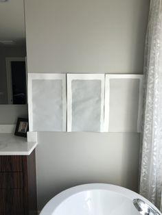 a white sink sitting next to a mirror in a bathroom