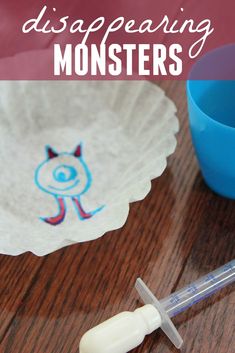 a disposaring monster paper plate next to a blue cup and syosher