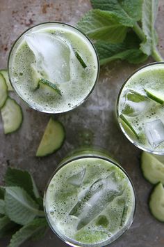 three glasses filled with cucumber and mint juice