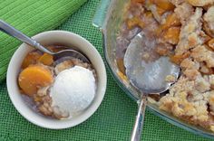 a bowl filled with ice cream next to a dish full of fruit cobbbers