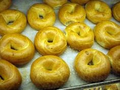 there are many bagels on the tray ready to be baked in the ovens