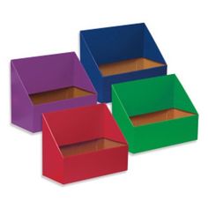 four different colored boxes are stacked on top of each other