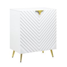 a white cabinet with gold legs and a chevron pattern on the front, against a white background