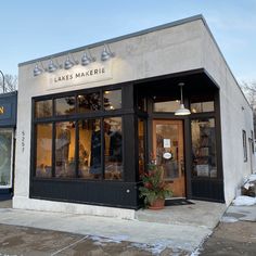 the front of a clothing store with snow on the ground