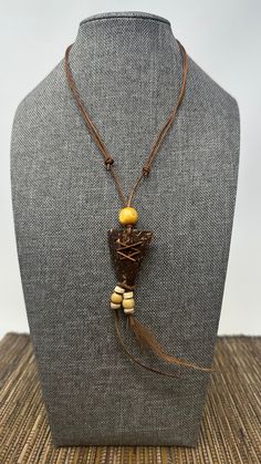 🌎 Handmade Indian-Style Arrowhead Necklace with Coconut Shell Pendant and Brown Feather Accents 🔷 The Beauty of Tradition: Indulge in the beauty of tradition with our exquisite handmade Indian-style necklace. This unique piece channels the spirit of the ancient tribes, crafted to resonate with the timeless aesthetics of indigenous American jewelry.  🌲 Arrowhead Pendant - A Symbol of Strength: The standout feature of this necklace is its arrowhead pendant, a symbol deeply ingrained in Native American culture. This pendant, carefully carved from coconut shell wood, signifies protection, courage, and strength. 🍃 Feathers - Symbols of Honor: Hanging delicately from the arrowhead's bottom point are two brown feathers. In Native American culture, feathers symbolize trust, honor, strength, wi Traditional Necklace As A Gift, Traditional Natural Color Necklace For Gift, Rustic Adjustable Natural Necklace, Rustic Wooden Beads Jewelry As A Gift, Festival Brown Hand-wrapped Necklaces, Rustic Jewelry With Wooden Beads For Gifts, Festival Hand Wrapped Brown Necklace, Nature-inspired Brown Jewelry For Festivals, Traditional Brown Adjustable Necklace