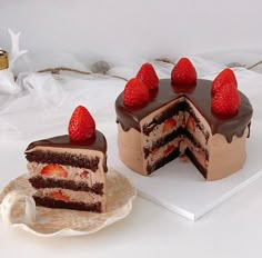 there is a chocolate cake with strawberries on top and a slice missing from it