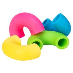 three different colored plastic objects on a white background