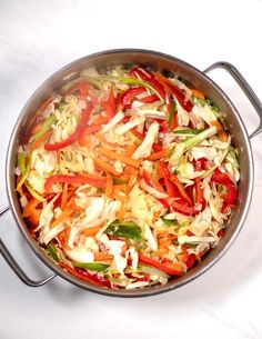 a pan filled with vegetables on top of a white counter