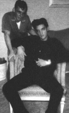 black and white photograph of two men sitting on a couch