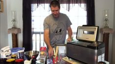 a man standing in front of a stove with ingredients on the counter next to him