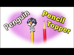 the penguin pencil topper is next to two candles