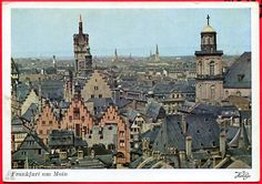 an aerial view of a city with tall buildings and steeple tops in the distance