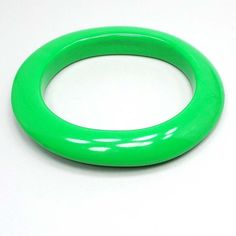 "Fun bright green color that's great for stacking with your other bangles. Size: Bangle is oval shaped with inside opening of 2 1/4 x 2 5/8\".  Type: Pre Owned Mid Century Vintage from the 1960's.  Condition: Good vintage condition with no cracks or chips. Materials: Lucite plastic. Markings: Unsigned." Floral Cuff Bracelet, Floral Cuff, Green Oval, Vintage Lucite, Mid Century Vintage, Black Enamel, Bright Green, Bangle Bracelet, Belt Buckles