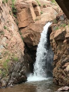 there is a waterfall coming out of the rocks