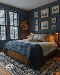 a bedroom with blue walls and pictures on the wall