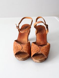 This is a pair of 1970s vintage Nobil's leather sandals. The brown leather open toe slingbacks have wooden heels. Buckle closure at ankle. Marked Made in Brazil.CONDITIONIn good condition with wear consistent with age and use. Small chip in the wood at the top of the heels. APPROXIMATE FIT: 10B USMEASUREMENTSInsole Length: 10.5" .. 26.7 cmWidth: 3" .. 7.6 cmHeel: 3.75" .. 9.5 cm92225Women’s sandals. Good condition, size 10. Detailed measurements:Length Of Sole - 10.5 inchesHeel Height - 3.75 inches Retro Closed Toe Sandals With Wooden Heel, Retro Sandals With Wooden Open Heel, Vintage Brown Sandals With Wooden Heel, Retro Leather Sandals With Wooden Heel, Vintage Leather Open Toe Sandals, Vintage Brown Sandals For Summer, Retro Brown Clogs For Summer, Brown Retro Summer Clogs, Retro Sandals With Wooden Heel And Ankle Strap