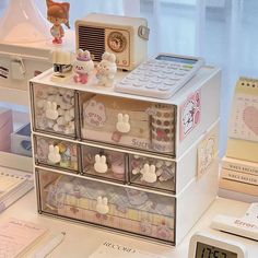 an assortment of toy items are sitting on a desk next to a clock and other office supplies