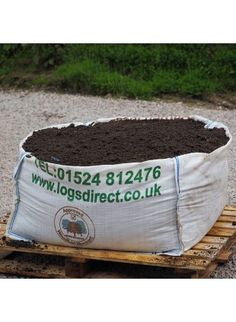 a large bag of dirt sitting on top of a pallet filled with dirt and gravel