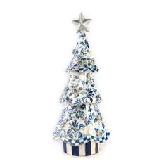 a ceramic christmas tree with blue and white designs on it's top, sitting in front of a white background