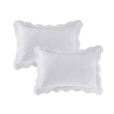 two white pillows sitting next to each other