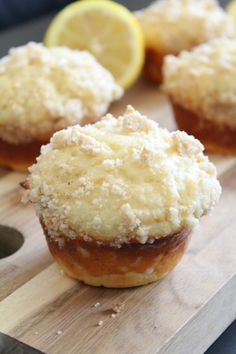 three lemon filled muffins sitting on top of a cutting board