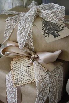 two presents wrapped in brown paper with lace on them