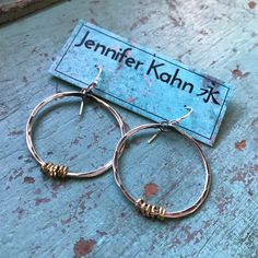 "These thick hammered hoops are a great every day size. Made of 14 gauge sterling wire that I've forged, oxidized and polished to a matte finish. I've added some tiny brass Ethiopian heishi beads for a mixed metal contrast. They hang from sterling earwires. 1 1/2\" diameter (2nd photo, small pair)" Hammered Artisan Hoop Earrings For Everyday, Artisan Hammered Round Hoop Earrings, Artisan Hammered Hoop Earrings For Everyday, Everyday Artisan Hammered Hoop Earrings, Artisan Small Hoop Hand Forged Earrings, Artisan Hoop Earrings With Ear Wire For Everyday, Artisan Hammered Hoop Jewelry, Artisan Hand Forged Small Hoop Earrings, Small Silver Hoop Earrings