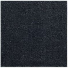 a black area rug that is on top of a white floor and it has a square shape