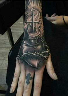 a person with a tattoo on their hand